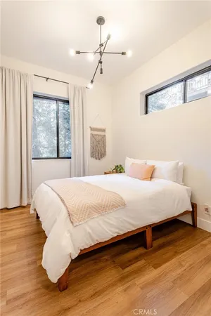 a large bed sitting in a bedroom next to a window