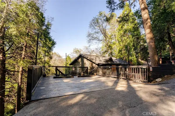 a view of house with backyard and trees