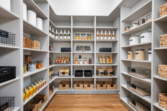 2867 East Granite Way St. George, UT 84790 - Photo 20 of 69 Custom-built pantry featuring extensive shelving, corner storage, adjustable shelf heights, integrated lighting, and wood-finish flooring