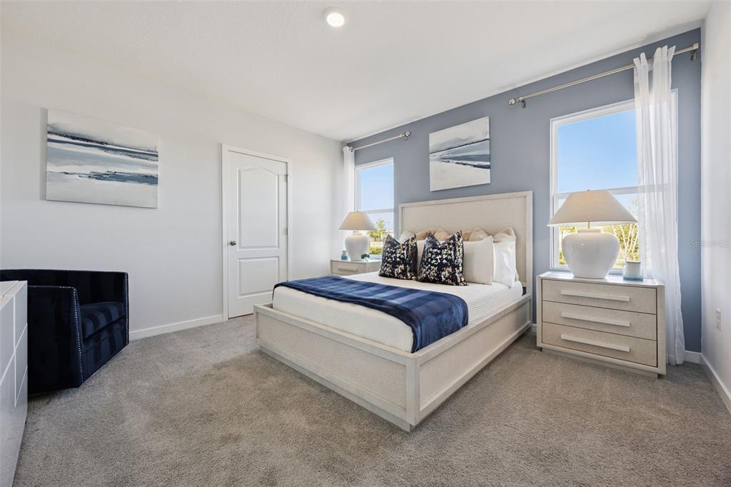 3019 House Finch Road St. Cloud, FL 34773 - Photo 12 of 54 a bedroom with a bed and a fireplace