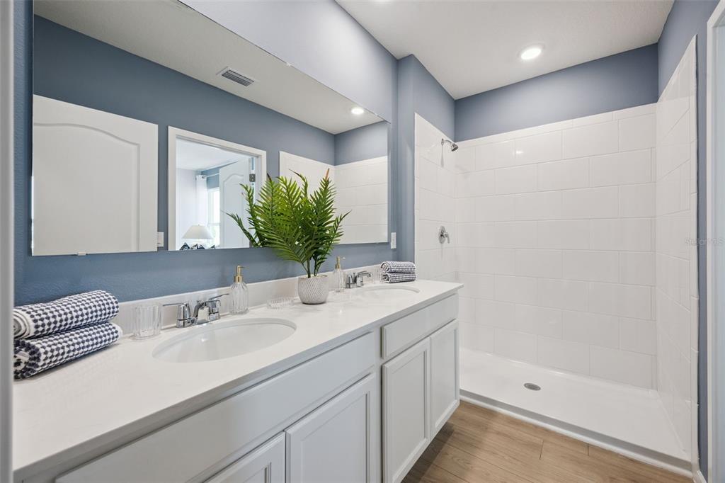 3019 House Finch Road St. Cloud, FL 34773 - Photo 14 of 54 a bathroom with a sink and a mirror