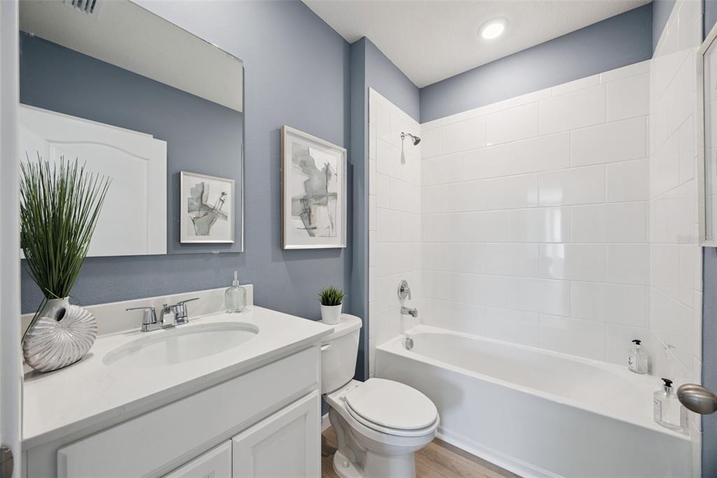 3019 House Finch Road St. Cloud, FL 34773 - Photo 15 of 54 a bathroom with a sink toilet and shower