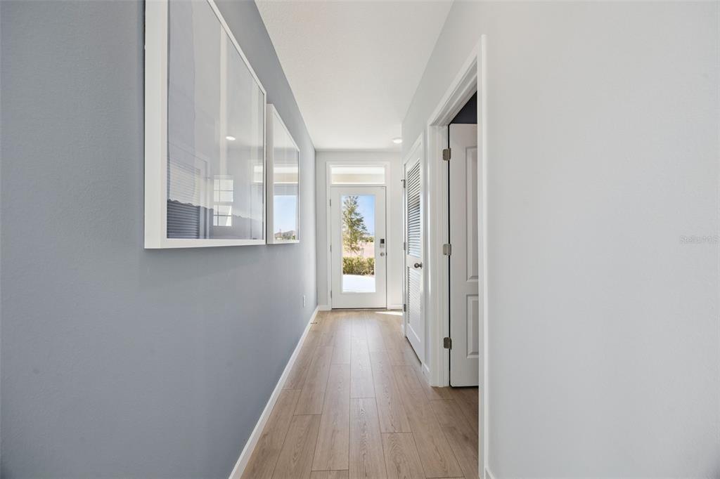 3019 House Finch Road St. Cloud, FL 34773 - Photo 2 of 54 a view of a hallway with wooden floor and a window