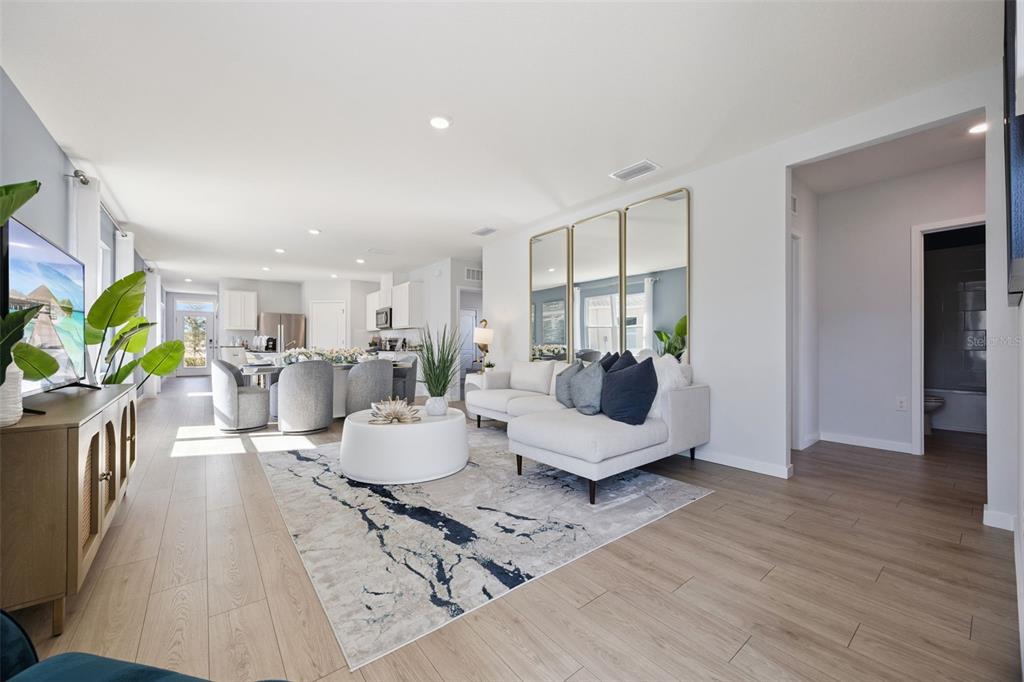 3019 House Finch Road St. Cloud, FL 34773 - Photo 3 of 54 a living room with furniture and a wooden floor