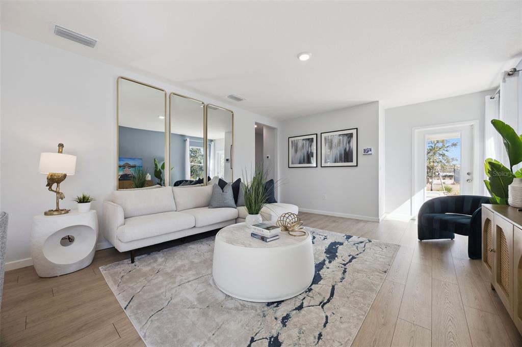 3019 House Finch Road St. Cloud, FL 34773 - Photo 4 of 54 a living room with furniture and a potted plant