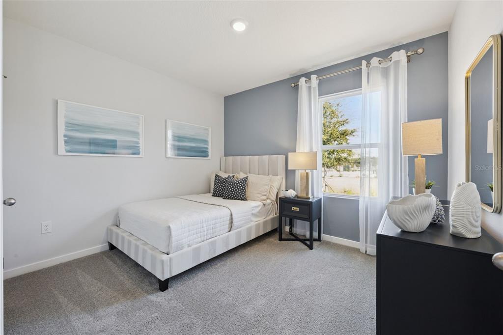 3019 House Finch Road St. Cloud, FL 34773 - Photo 10 of 54 a bed room with a bed and a window