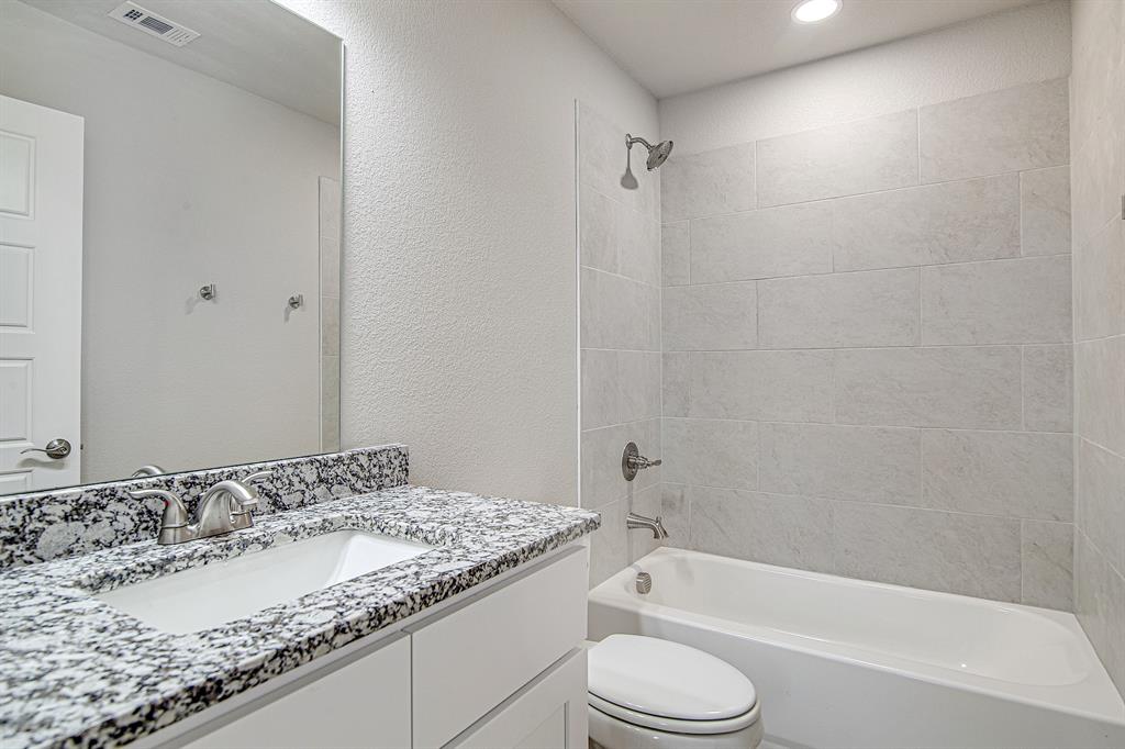 320 West Gambrell Street Fort Worth, TX 76115 - Photo 29 of 40 a bathroom with a granite countertop sink toilet and bathtub