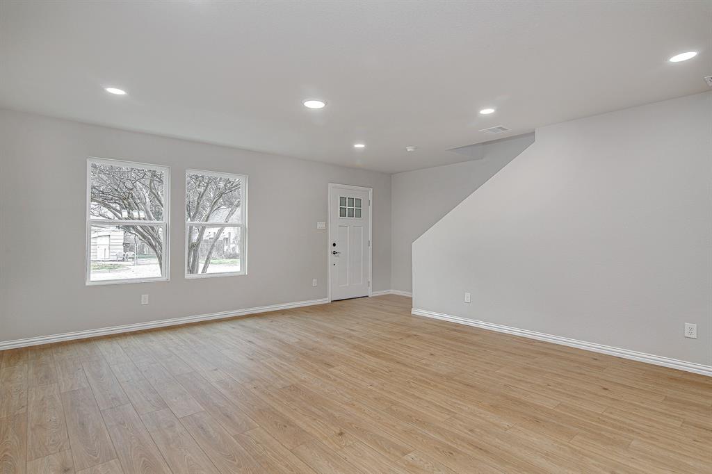 320 West Gambrell Street Fort Worth, TX 76115 - Photo 37 of 40 an empty room with wooden floor and windows