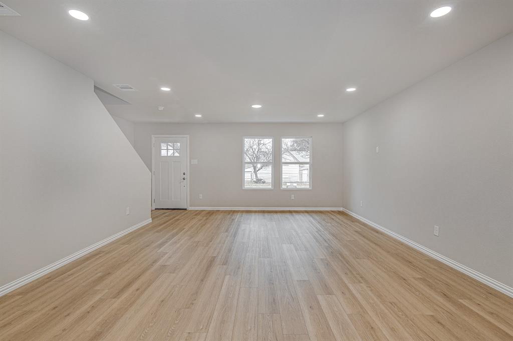 320 West Gambrell Street Fort Worth, TX 76115 - Photo 7 of 40 an empty room with wooden floor and windows