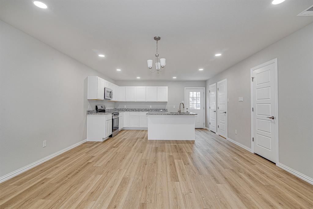 320 West Gambrell Street Fort Worth, TX 76115 - Photo 9 of 40 a view of kitchen with wooden floor