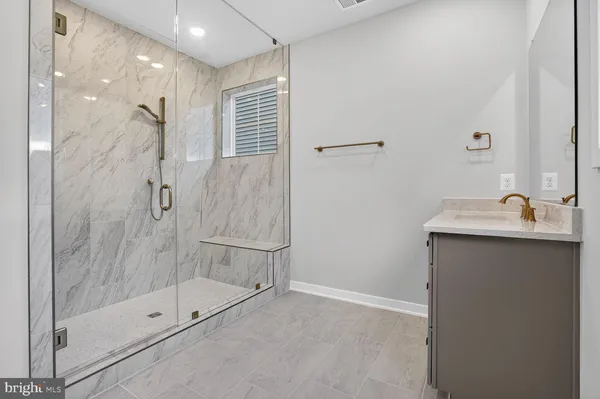 a bathroom with a shower sink and mirror