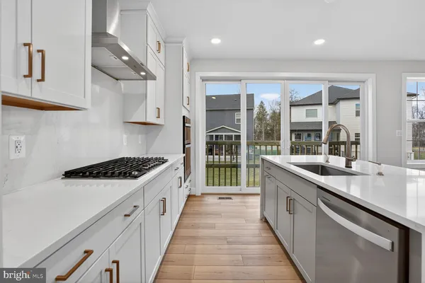 a kitchen with stainless steel appliances granite countertop a stove and a sink