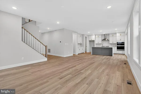 a view of a kitchen with wooden floor and a sink