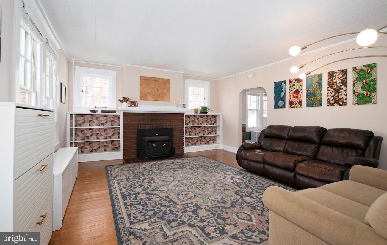 1505 3rd Avenue York, PA 17403 - Photo 2 of 12 a living room with furniture a fireplace and a large window
