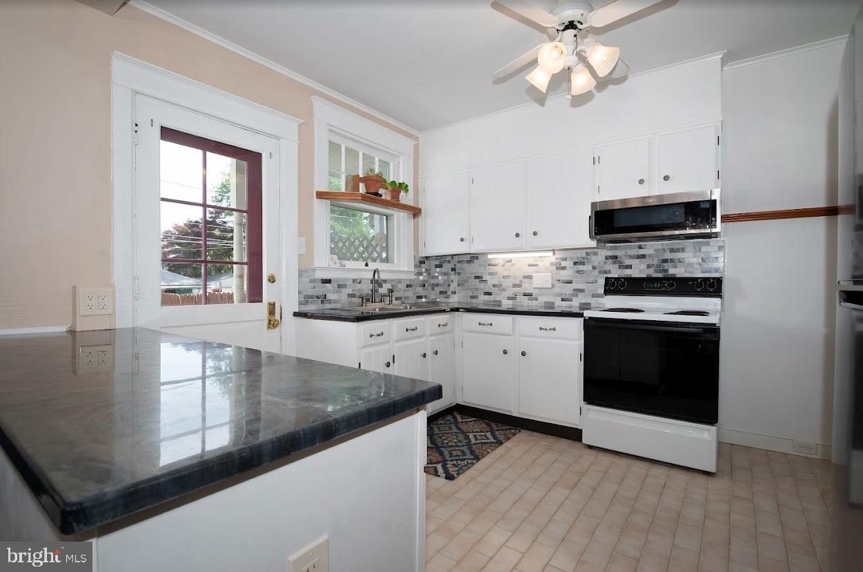 1505 3rd Avenue York, PA 17403 - Photo 5 of 12 a kitchen with stainless steel appliances granite countertop a stove and a sink