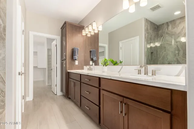 a bathroom with a double vanity sink and a mirror