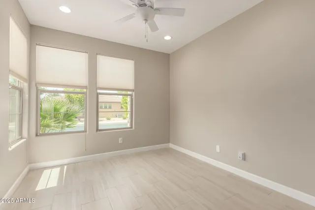 an empty room with a window and wooden floor