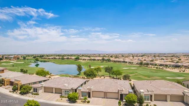 an aerial view of residential houses with outdoor space and ocean view