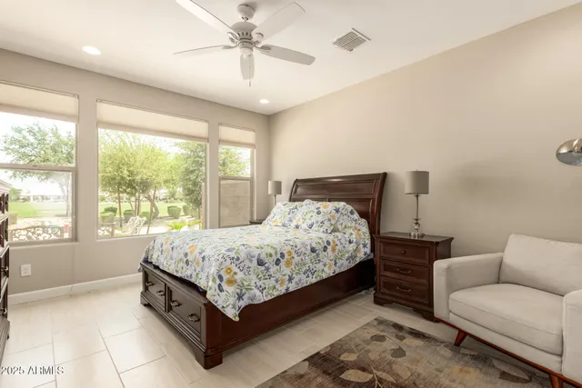 a bedroom with a bed couch and window