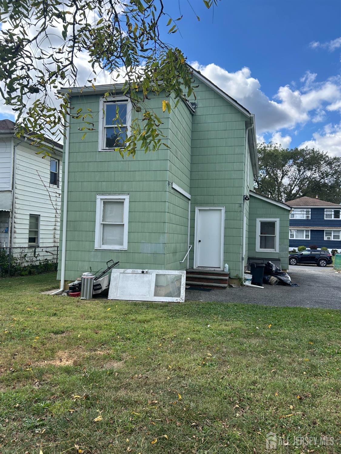 239 North 10th Street Kenilworth, NJ 07033 - Photo 4 of 8 a house view with a sitting space and garden