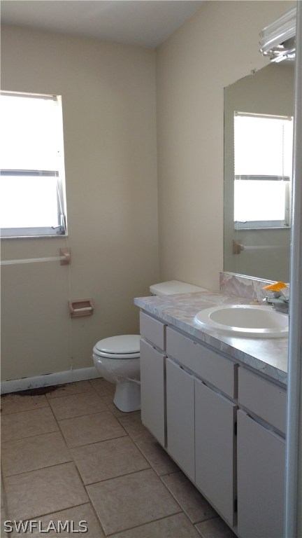 7550 Garry Road Fort Myers, FL 33967 - Photo 15 of 23 a bathroom with a granite countertop toilet a sink and a window