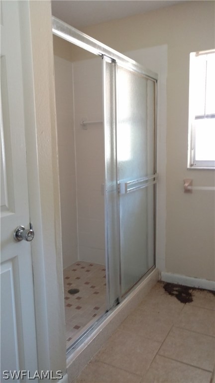 7550 Garry Road Fort Myers, FL 33967 - Photo 16 of 23 a bathroom with a glass shower door