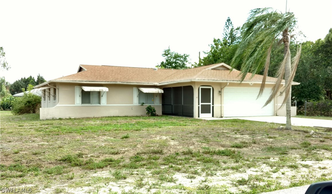 7550 Garry Road Fort Myers, FL 33967 - Photo 2 of 23 a front view of a house with garden
