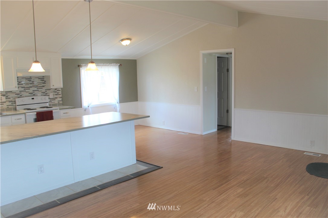 41 Sand Flat Road Omak, WA 98841 - Photo 3 of 18 a large kitchen with kitchen island a sink dishwasher a stove and a wooden floor