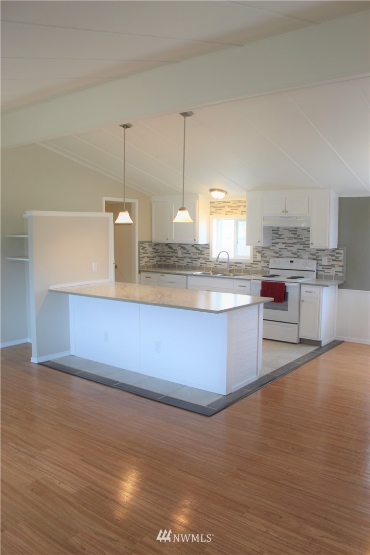 41 Sand Flat Road Omak, WA 98841 - Photo 4 of 18 a kitchen with stainless steel appliances granite countertop a sink a stove and a wooden floors