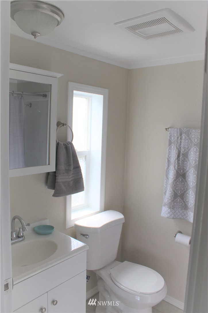 41 Sand Flat Road Omak, WA 98841 - Photo 8 of 18 a white toilet sitting next to a bathroom sink