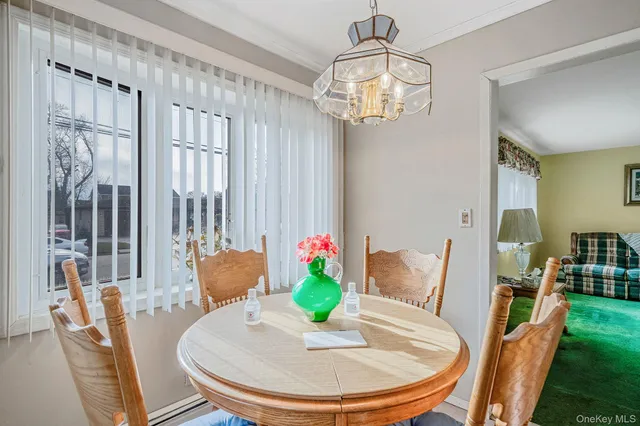 a view of a dining room with furniture a chandelier and wooden floor