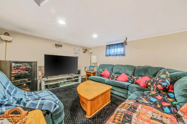 a bedroom with furniture and a flat screen tv