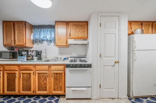 a kitchen with a refrigerator and cabinets