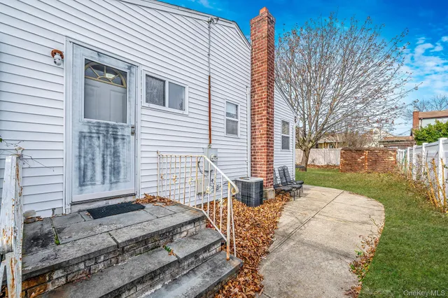 a view of a house with a yard and pathway