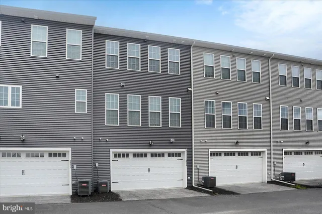 a front view of a building with parking