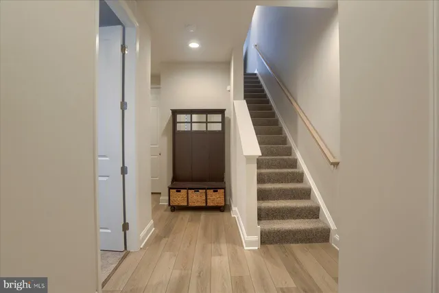 a view of entryway and hall with wooden floor