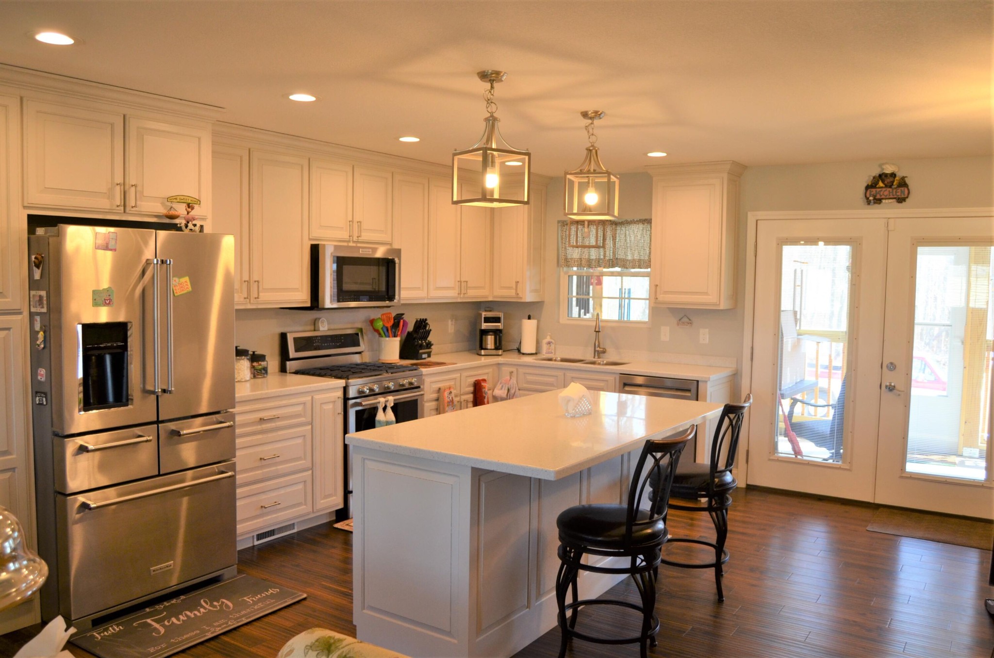 1039 Plateau Road Crossville, TN 38571 - Photo 14 of 40 a kitchen with a refrigerator a microwave a stove and white cabinets with wooden floor