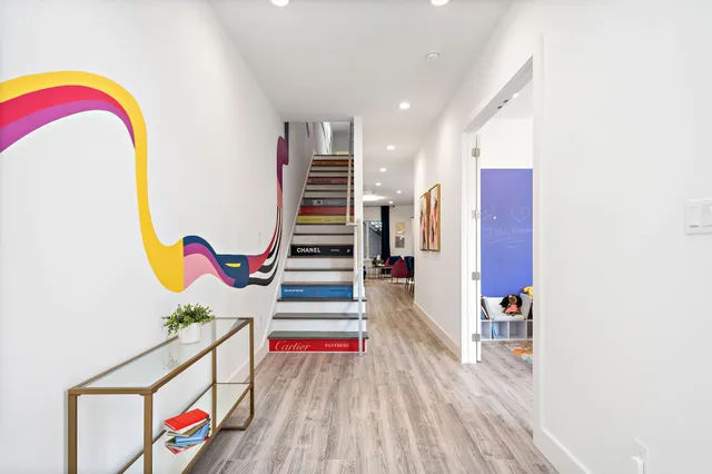 a bathroom with a granite countertop sink a toilet and a mirror