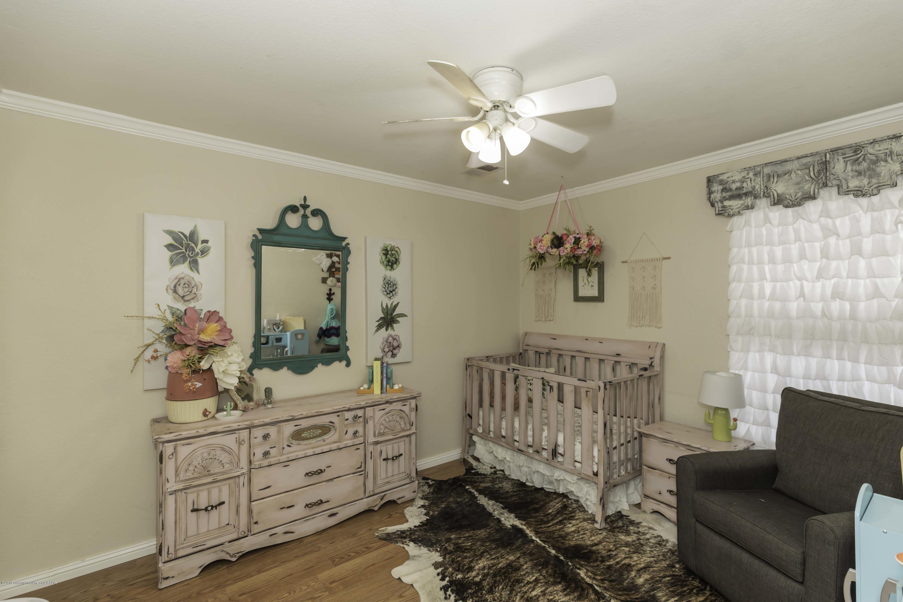 5308 Wheeler Lane Amarillo, TX 79110 - Photo 22 of 41 a living room with furniture and a chandelier