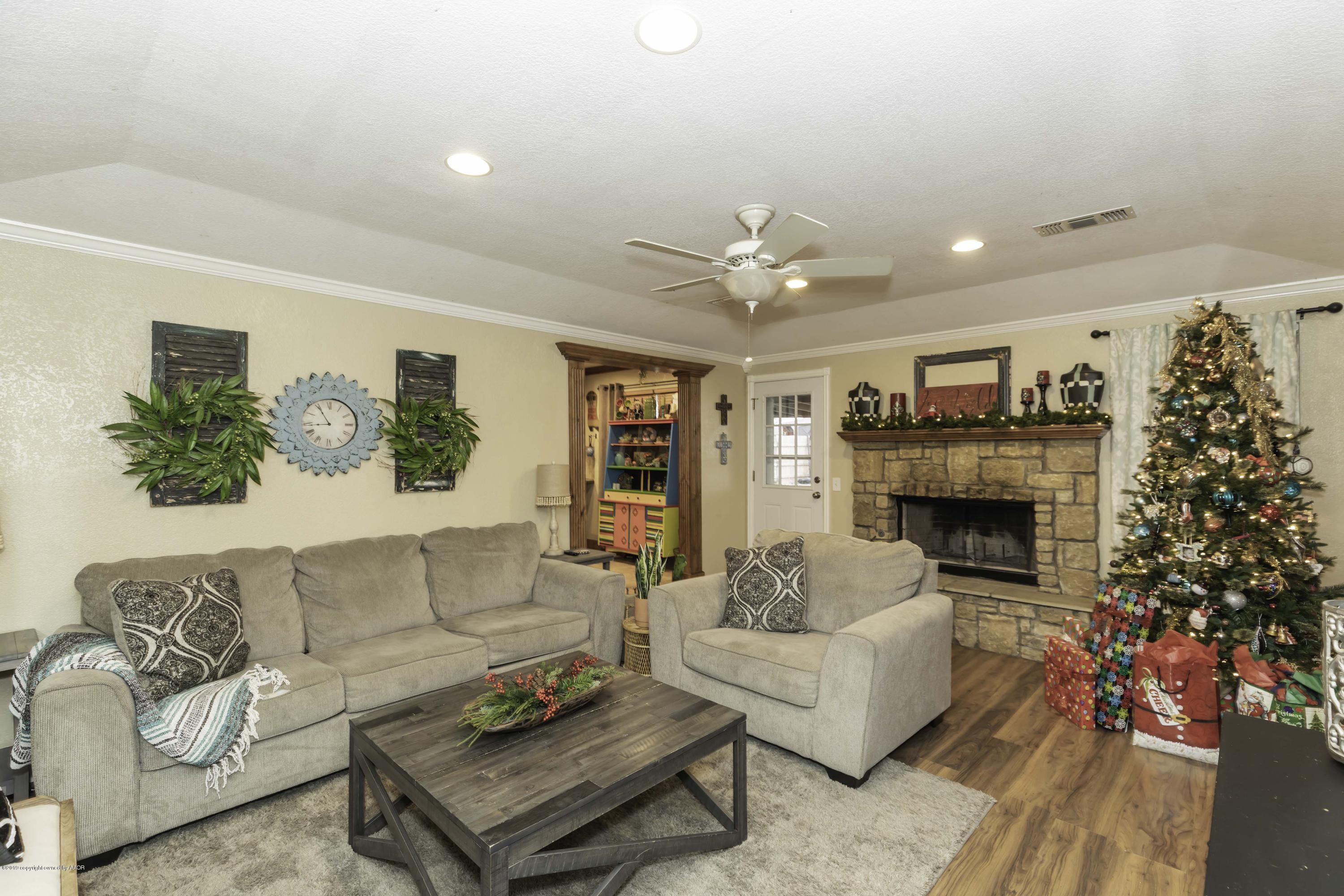 5308 Wheeler Lane Amarillo, TX 79110 - Photo 5 of 41 a living room with furniture and a fireplace