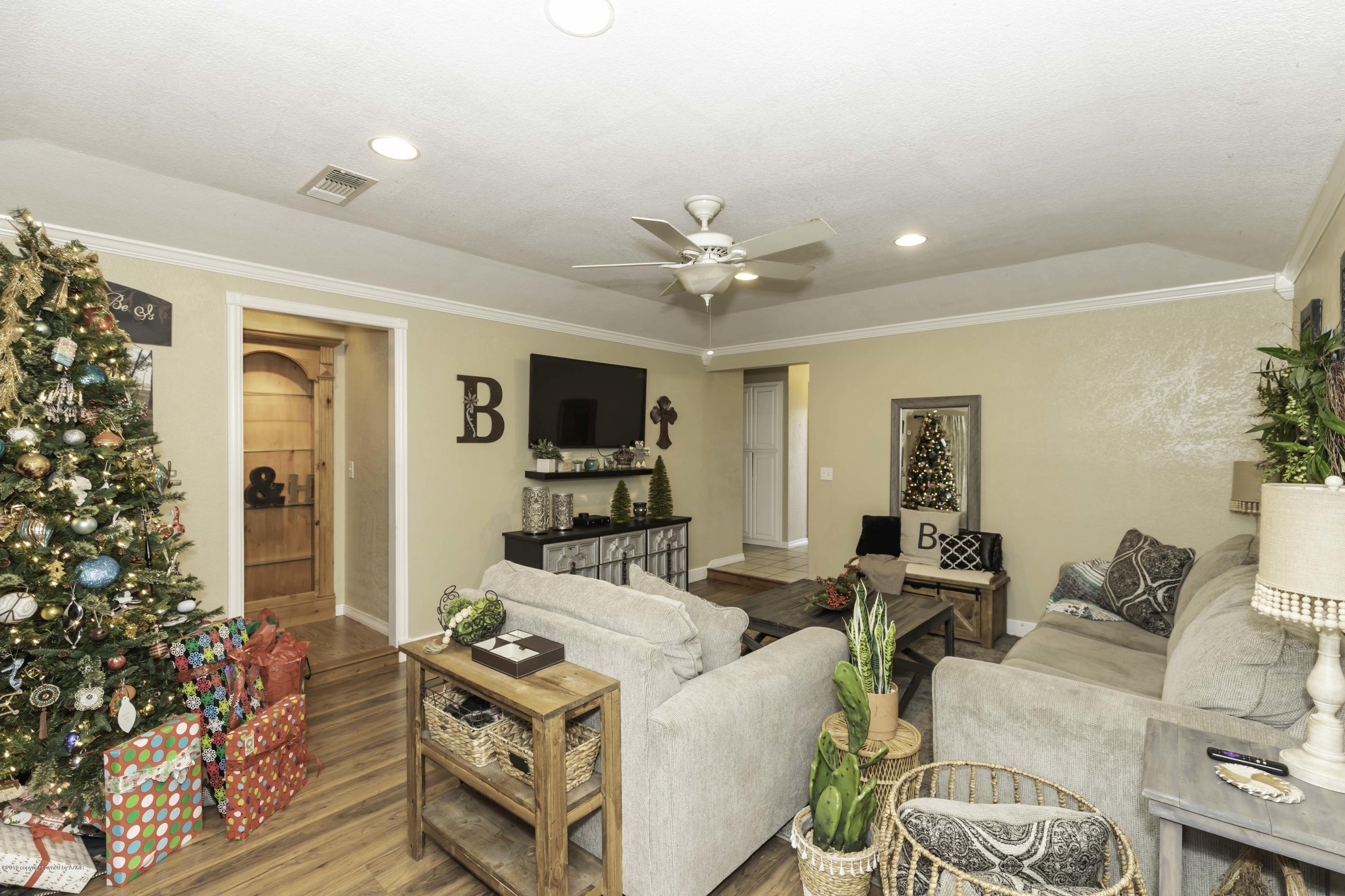 5308 Wheeler Lane Amarillo, TX 79110 - Photo 6 of 41 a living room with furniture and a flat screen tv