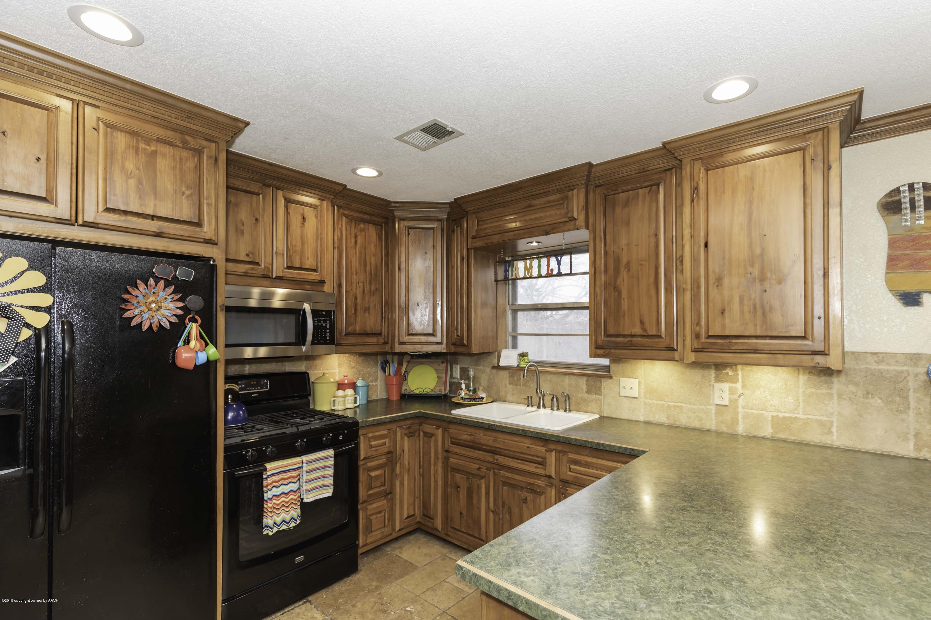 5308 Wheeler Lane Amarillo, TX 79110 - Photo 9 of 41 a kitchen with stainless steel appliances granite countertop a refrigerator stove top oven and sink