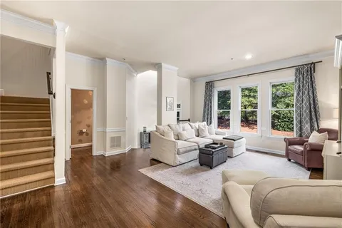 a living room with furniture and large windows