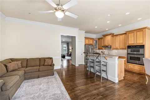 a living room with furniture and kitchen view