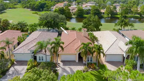 an aerial view of a house with garden space and lake view
