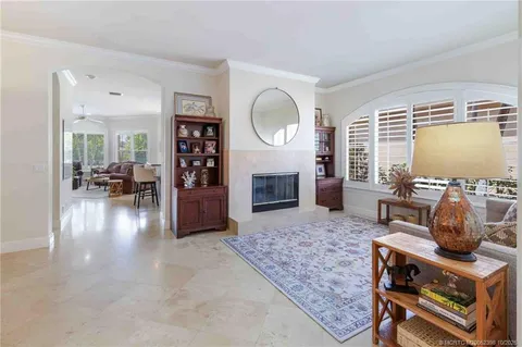 a kitchen with kitchen island granite countertop a sink stove and cabinets