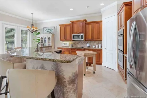a kitchen with a sink and a refrigerator