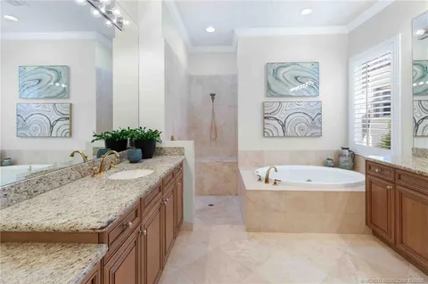 an aerial view of a house with a garden and lake view