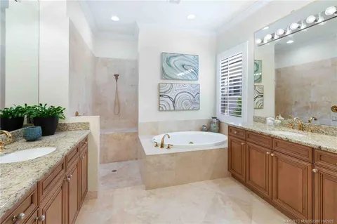 a street sign on a wall next to a road