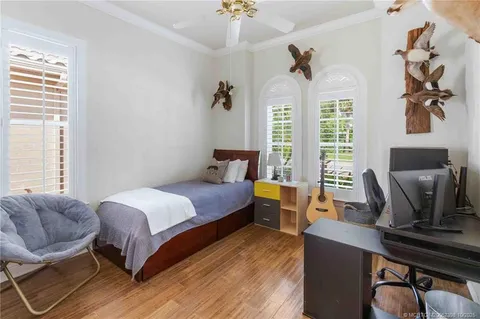 a front view of house with yard and trees in the background